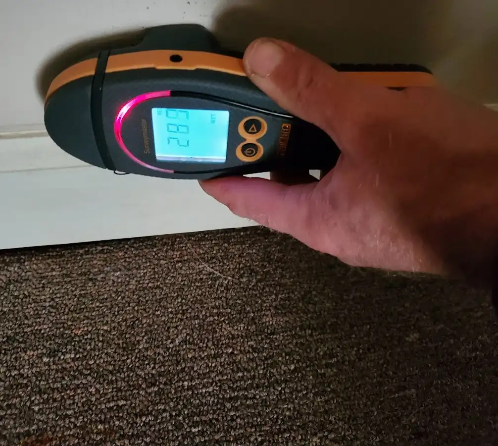Moisture detection at baseboard during Storm Damage Restoration in Egelston